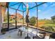 Screened patio with table and chairs, overlooking yard at 5502 Bounty Cir, Tavares, FL 32778