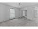 Bedroom with mirrored closet doors, ceiling fan and window with curtains at 5530 Tangelo St, Leesburg, FL 34748