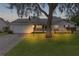 Evening view of a single story home with well-lit lawn at 5530 Tangelo St, Leesburg, FL 34748