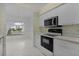 Kitchen with white cabinets and a view to the dining area at 5530 Tangelo St, Leesburg, FL 34748