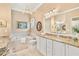 Bathroom with double vanity and garden tub at 6216 Landings Blvd, Lady Lake, FL 32159