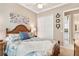 Bedroom features ceiling fan, closet, and a view into the bathroom at 6216 Landings Blvd, Lady Lake, FL 32159