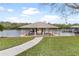 Covered boat dock with sitting area, perfect for enjoying lake views at 6216 Landings Blvd, Lady Lake, FL 32159