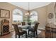 Elegant dining room with glass table and hardwood floors at 6216 Landings Blvd, Lady Lake, FL 32159