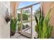 Bright and airy entryway with a screened door and potted plants at 6216 Landings Blvd, Lady Lake, FL 32159