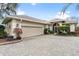 Attractive single-story home with a paver driveway and lush landscaping at 6216 Landings Blvd, Lady Lake, FL 32159