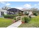 Front view of charming house with walkway and landscaping at 6216 Landings Blvd, Lady Lake, FL 32159