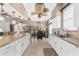 Well-lit kitchen with marble countertops and seamless view into the dining room at 6216 Landings Blvd, Lady Lake, FL 32159