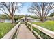 Wooden walkway leads to a waterfront boat dock at 6216 Landings Blvd, Lady Lake, FL 32159