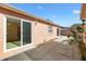 A home exterior reveals a concrete patio with sliding glass doors and a well-manicured garden bed at 629 Nuevo Leon Ln, The Villages, FL 32159