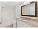 Bright bathroom with a granite countertop vanity, white cabinetry, and a shower and tub combination at 629 Nuevo Leon Ln, The Villages, FL 32159