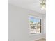 Bright bedroom featuring neutral walls and a window with shutters showcasing the landscape outside at 629 Nuevo Leon Ln, The Villages, FL 32159