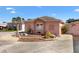 A well-kept home exterior features a colorful rock garden and manicured landscaping at 629 Nuevo Leon Ln, The Villages, FL 32159