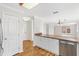 Bright kitchen with white cabinets, modern appliances, and sleek countertop opening to dining area at 629 Nuevo Leon Ln, The Villages, FL 32159