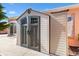 A sturdy outdoor storage shed features double doors and is perfect for backyard organization at 629 Nuevo Leon Ln, The Villages, FL 32159