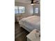 Bright bedroom with king-size bed and hardwood floors at 7 Cocos Plumosa Dr # A, Eustis, FL 32726