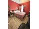 Red-walled bedroom with a queen-size bed at 762 Squirrel Ct, Kissimmee, FL 34759