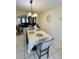 Bright dining room featuring a large table, chandelier, and view into the living room at 762 Squirrel Ct, Kissimmee, FL 34759