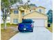 Two-story house with a two-car garage and a paved driveway at 762 Squirrel Ct, Kissimmee, FL 34759