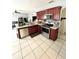 Modern kitchen with stainless steel appliances and wood cabinets at 762 Squirrel Ct, Kissimmee, FL 34759