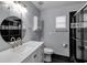 Modern bathroom with a white vanity and black tile at 7798 Snowberry Cir, Orlando, FL 32819