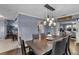 Bright dining room with farmhouse table and sliding barn door to the Primary bedroom at 7798 Snowberry Cir, Orlando, FL 32819