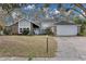 Two-story house with gray siding, brick accents, and a two-car garage at 7798 Snowberry Cir, Orlando, FL 32819