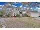 Two-story house with gray siding, brick accents, and a two-car garage at 7798 Snowberry Cir, Orlando, FL 32819