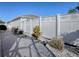 Private backyard with white vinyl fence, gravel pathway, and small landscaping at 8480 Se 167Th Forsyth St, The Villages, FL 32162