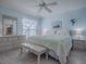 Light blue bedroom with king-size bed, dresser, and ceiling fan at 8480 Se 167Th Forsyth St, The Villages, FL 32162