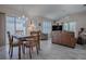 Bright dining area with wood table and chairs, adjacent to living room at 8480 Se 167Th Forsyth St, The Villages, FL 32162