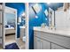 Gray vanity with blue walls and view into bedroom at 9033 Laurel Ridge Dr, Mount Dora, FL 32757