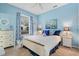 Light and airy bedroom with white bed frame and dresser at 9033 Laurel Ridge Dr, Mount Dora, FL 32757