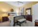 Bedroom with dark wood dresser and bench at foot of bed at 9033 Laurel Ridge Dr, Mount Dora, FL 32757