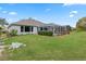 Single story home with well-manicured lawn and screened patio at 9033 Laurel Ridge Dr, Mount Dora, FL 32757