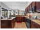 L-shaped kitchen with an island, lots of counter space and stainless steel appliances at 9033 Laurel Ridge Dr, Mount Dora, FL 32757