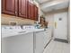 Bright laundry room with washer, dryer, and ample cabinetry at 9033 Laurel Ridge Dr, Mount Dora, FL 32757