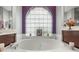 Soaking tub in the Primary bathroom with a large window at 9033 Laurel Ridge Dr, Mount Dora, FL 32757