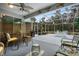 Relaxing screened patio with seating area and lush landscaping at 9033 Laurel Ridge Dr, Mount Dora, FL 32757