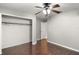 Bedroom with wood floors, closet, and door at 9320 County Road 125B, Wildwood, FL 34785