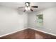 Simple bedroom with wood floors and a window at 9320 County Road 125B, Wildwood, FL 34785