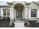 Inviting entryway with a dark green door and arched detail at 9320 County Road 125B, Wildwood, FL 34785