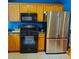 Kitchen area with stainless steel appliances and wood cabinets at 9616 Se 168Th Elderberry Pl, The Villages, FL 32162