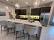 Modern kitchen with dark cabinetry, an island, and stainless steel appliances at 9918 Fiddley Aly, Orlando, FL 32827