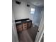 Bathroom with a double vanity, wood cabinets, black countertop, and a walk-in shower at Lot 42 Indian Estates Cr 423, Lake Panasoffkee, FL 33538