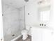 Modern bathroom featuring a marble-tiled shower and white vanity at Lot 42 Indian Estates Cr 423, Lake Panasoffkee, FL 33538
