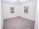 Bright bedroom featuring wood-look flooring, a ceiling fan, and natural light from the windows at Lot 42 Indian Estates Cr 423, Lake Panasoffkee, FL 33538