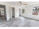 Bright bedroom with a ceiling fan, light gray floors, and large windows at Lot 42 Indian Estates Cr 423, Lake Panasoffkee, FL 33538