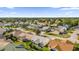 Aerial view of a residential neighborhood with houses and palm trees at 16967 Se 93Rd Cuthbert Cir, The Villages, FL 32162