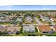 Aerial view of a residential neighborhood with houses and palm trees at 16967 Se 93Rd Cuthbert Cir, The Villages, FL 32162